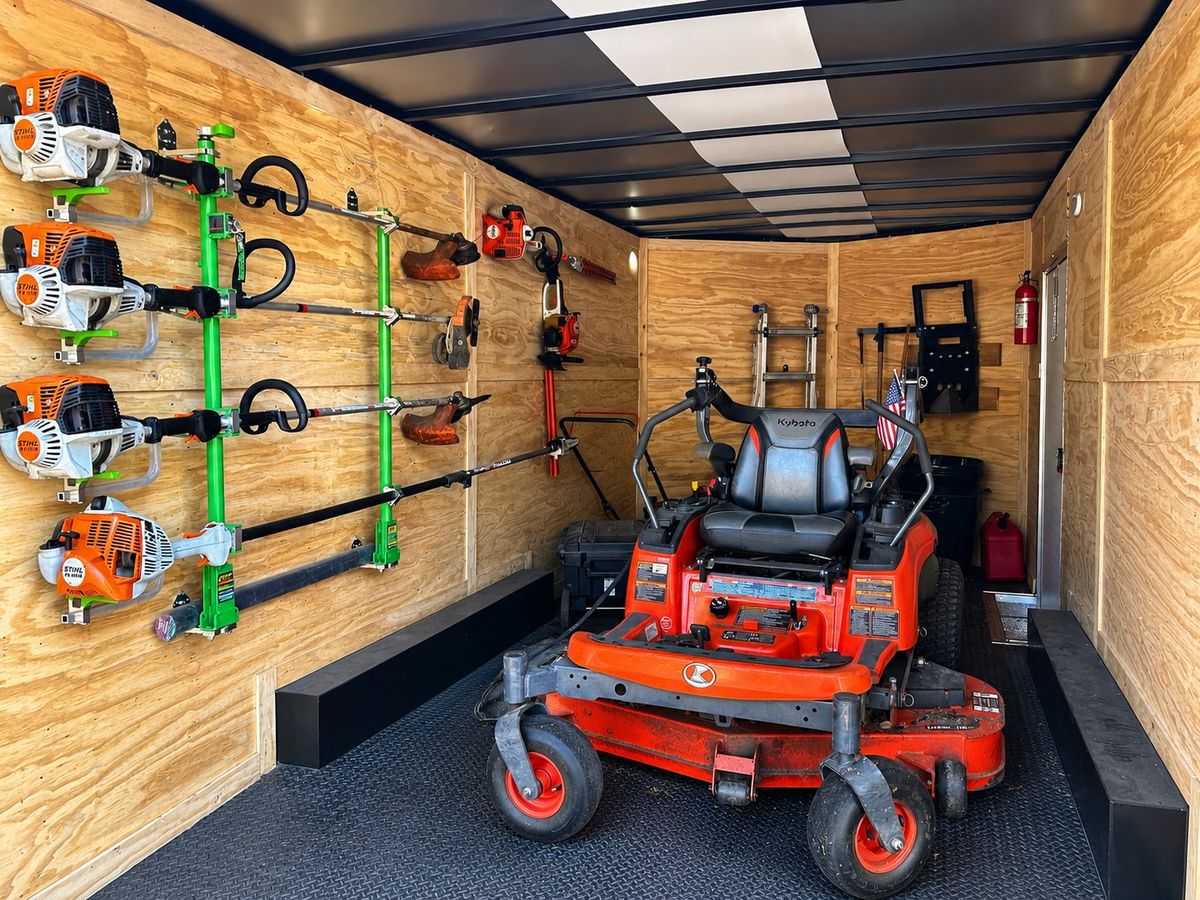 Enclosed trailer stocked with a commercial mower and trimmers